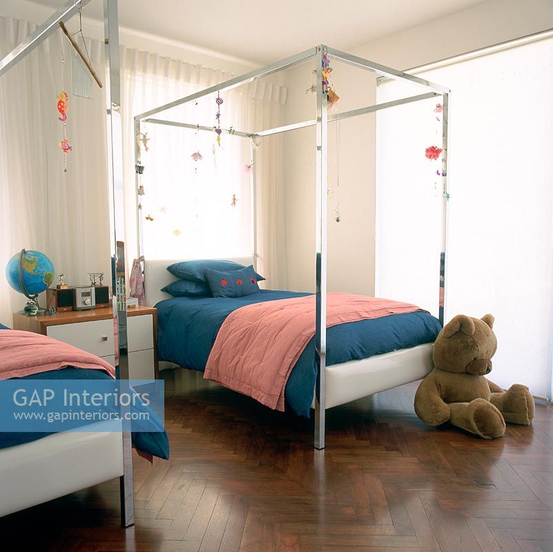 Children's bedroom with two four poster beds