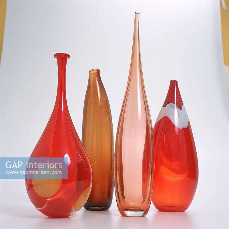 A collection of red glass vases