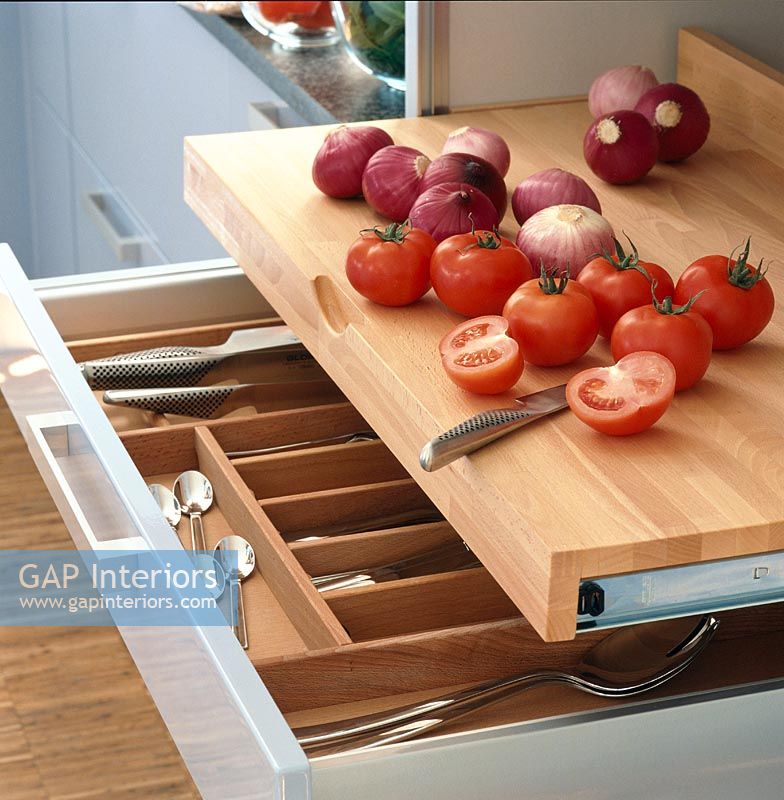 Cutlery drawer with vegetables on kitchen work top