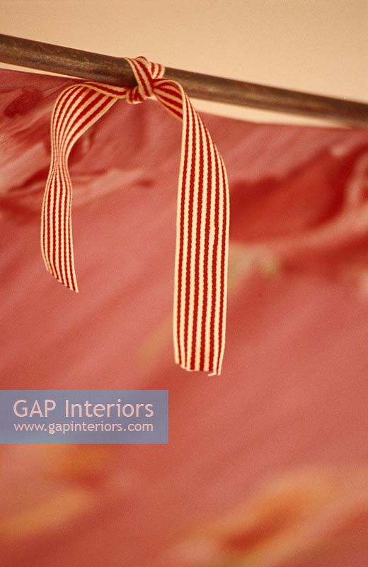 Close-up of a striped tie on a red sofa