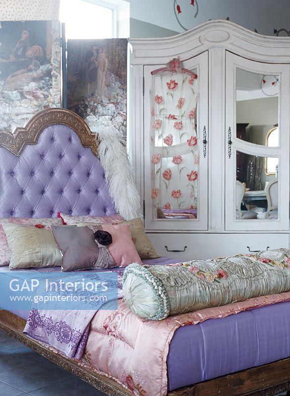 Elegant bed with purple comforter 