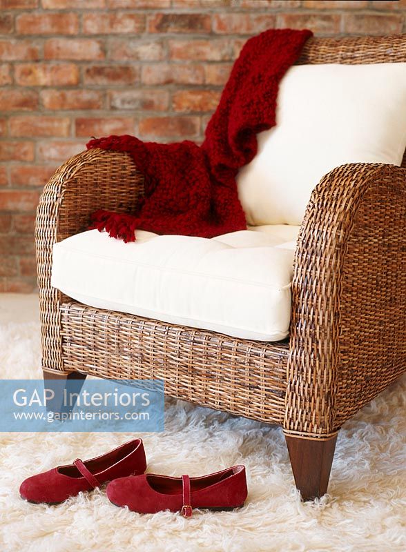 Wicker armchair with red shoes 