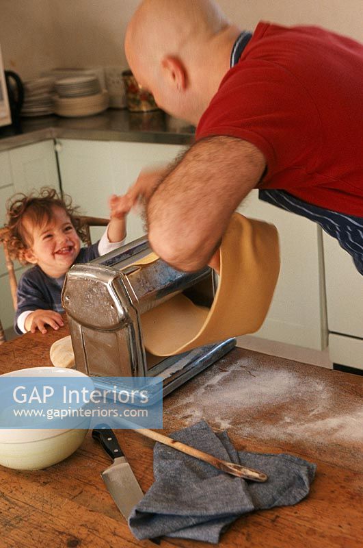 Father and son with pasta maker