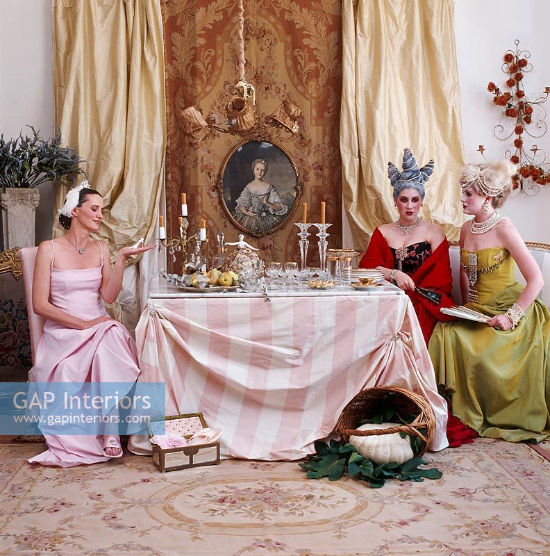 Three women sitting at dining table