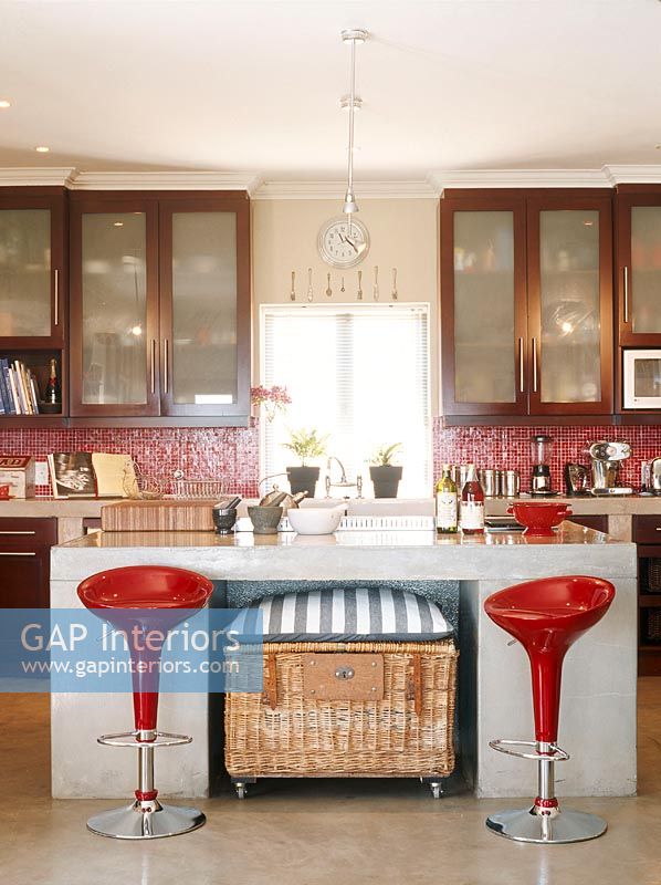 View of modern kitchen with red stools
