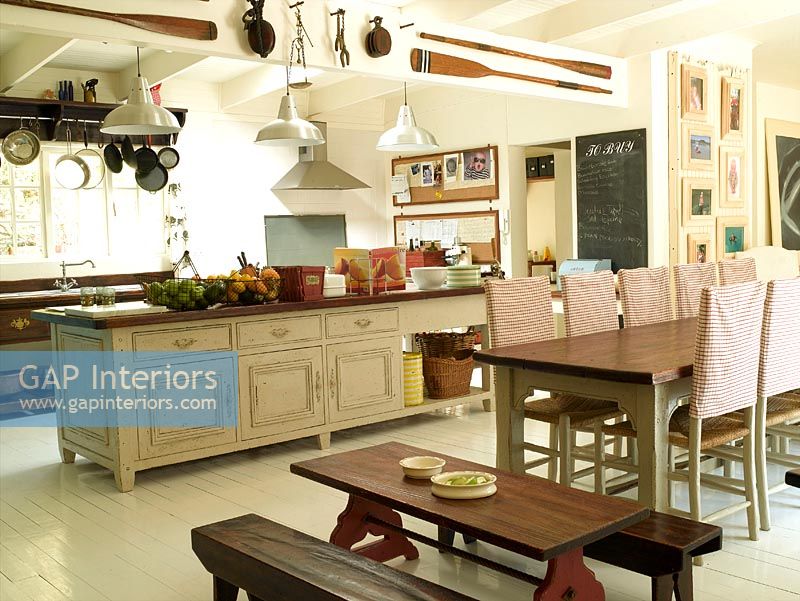 Country style kitchen with dining tables for adults and children