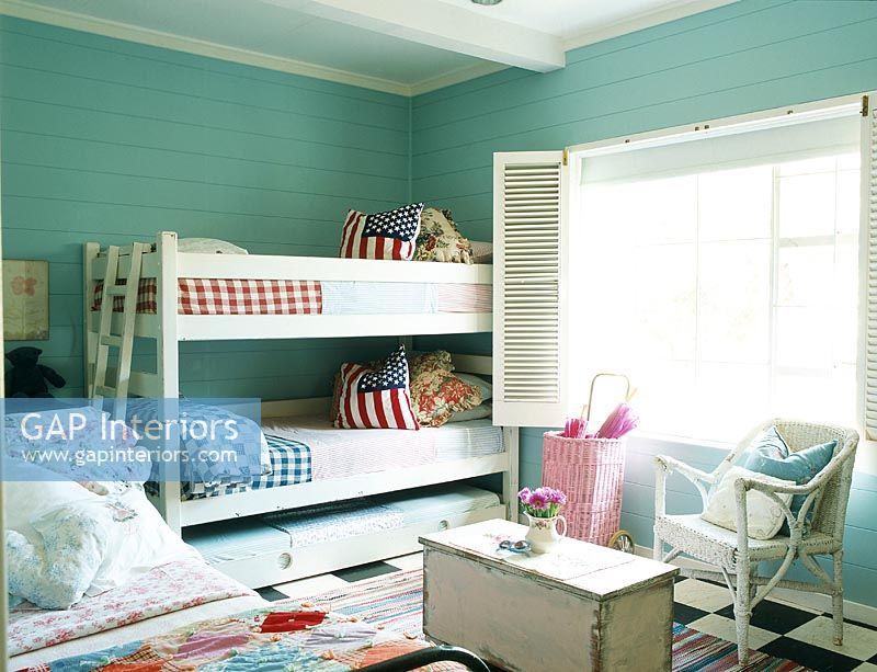 Bunk beds in bedroom with chair beside window