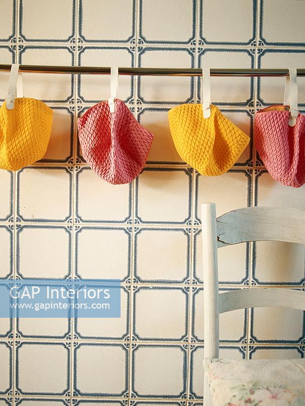 Collection of pink and yellow bathing caps drying on a clothesline