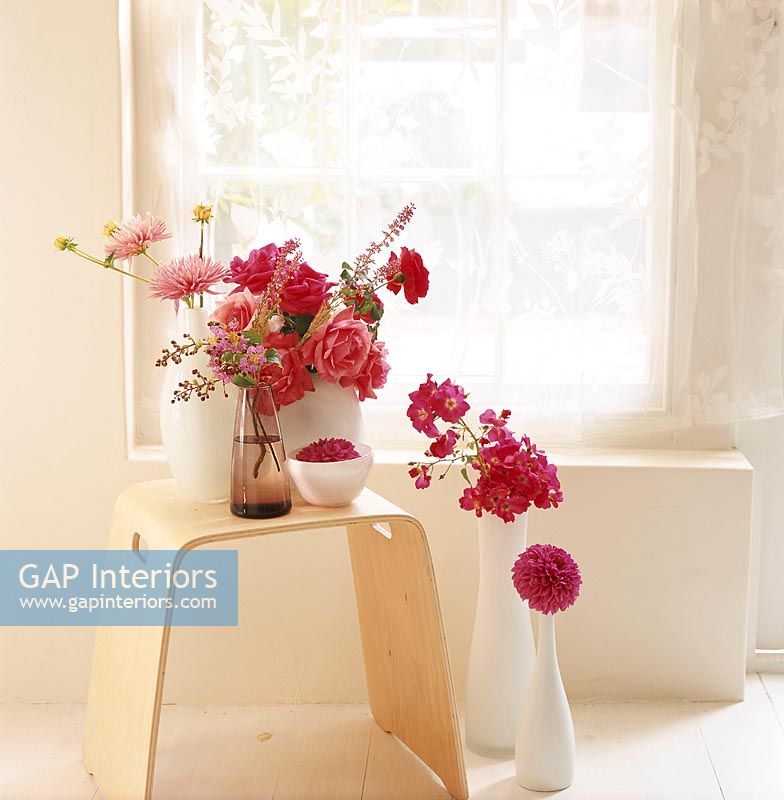 Flowers and vases on stool