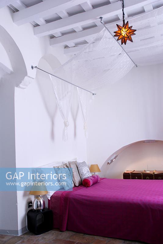 Bedroom with fabric canopy