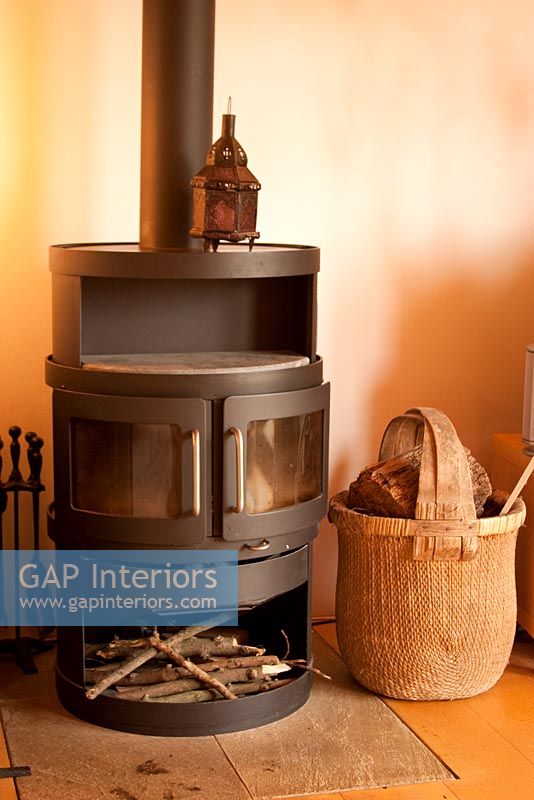 Wood burning stove and basket with logs