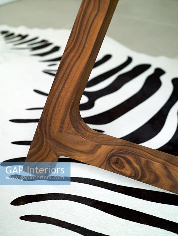 Detail of chair leg and modern black and white zebra print rug