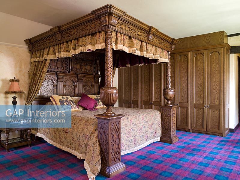 Traditional bedroom with tartan carpet and four poster bed