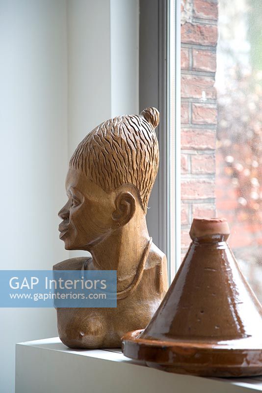 Wooden african sculpture and pot detail 