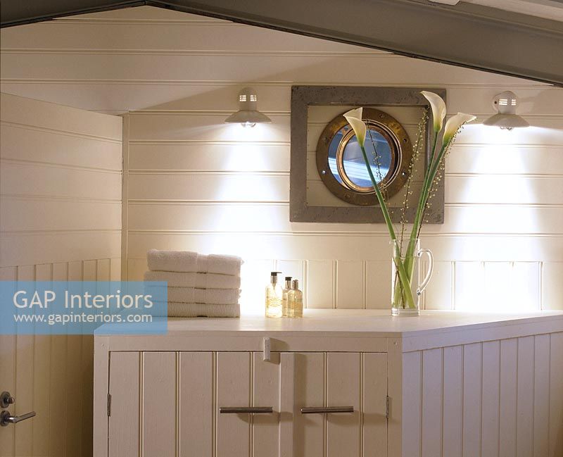 Porthole and cabinet in modern bathroom