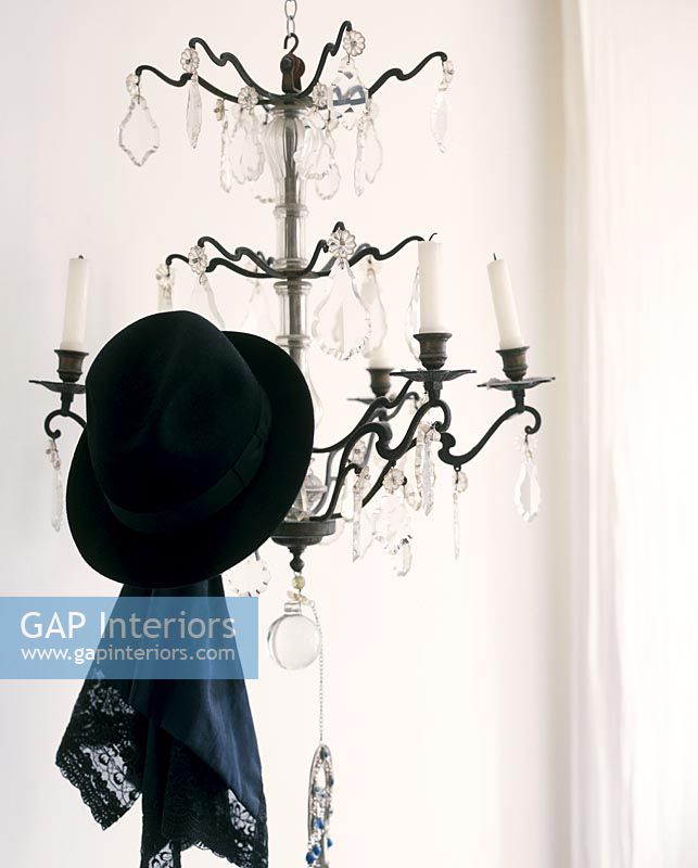 Hat hanging on chandelier 