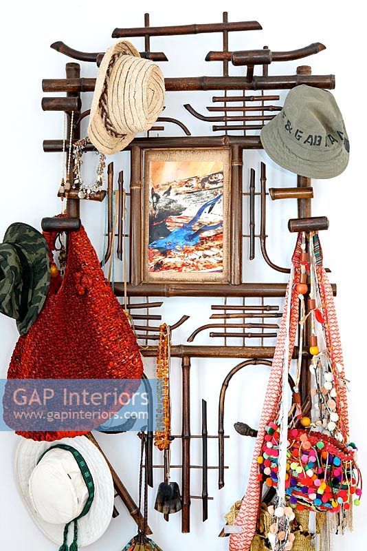 Hats and bags on wall mounted hooks