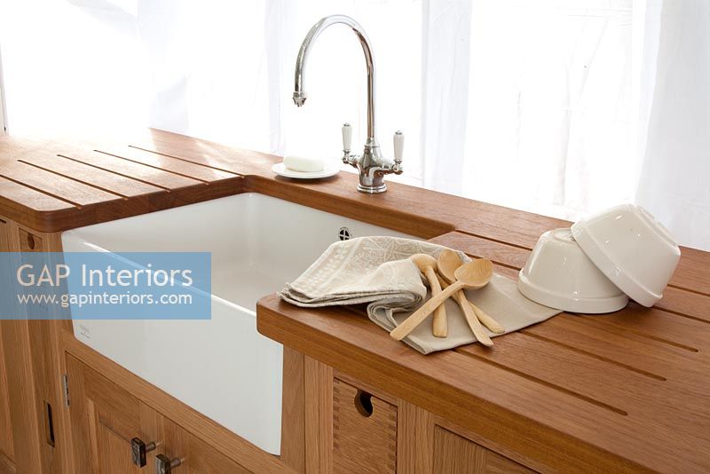 Butler sink in modern wooden kitchen 