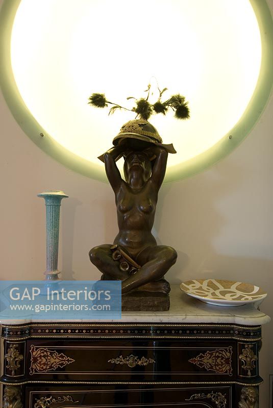 Sculpture lamp on ornate sideboard