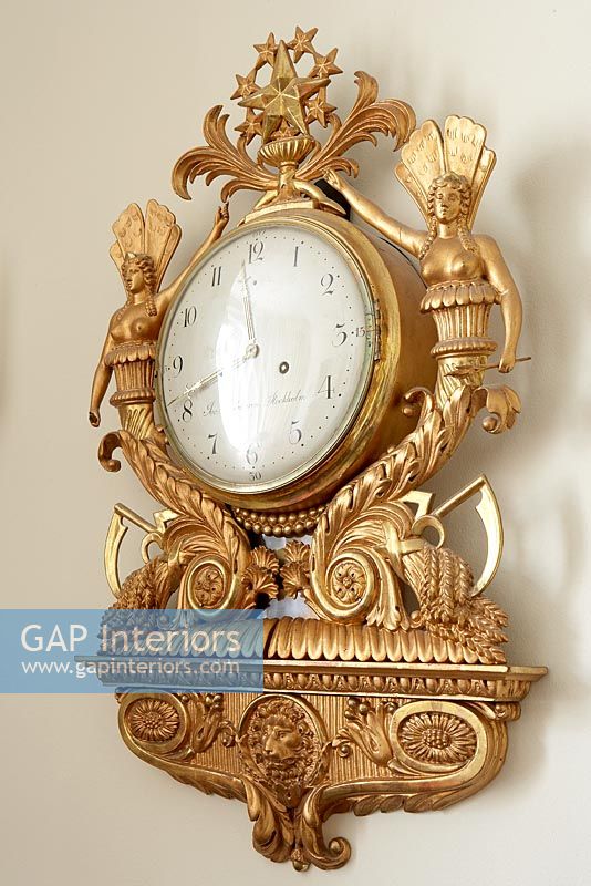 Ornate gold wall mounted clock