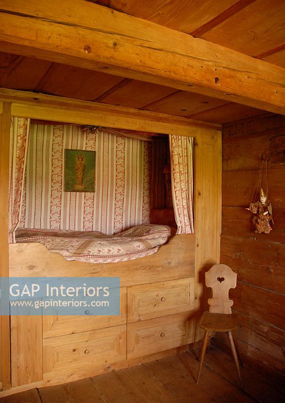 Built in wooden bed in country bedroom 
