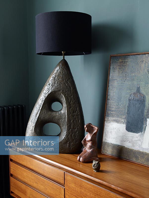 Stone sculptured lamp on sideboard