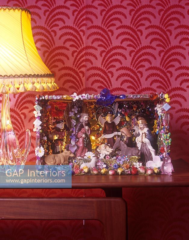 Colourful nativity scene on sideboard 