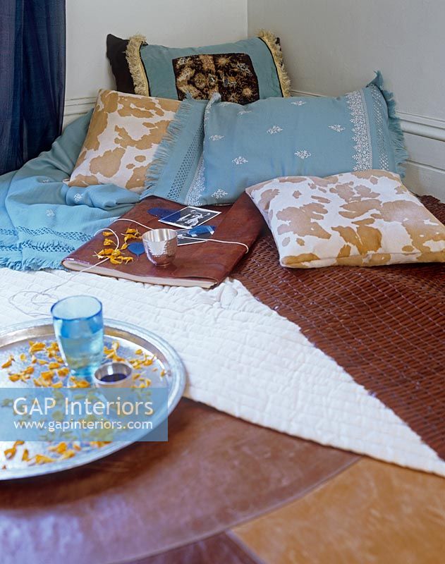 Cushions and fabrics on living room floor 