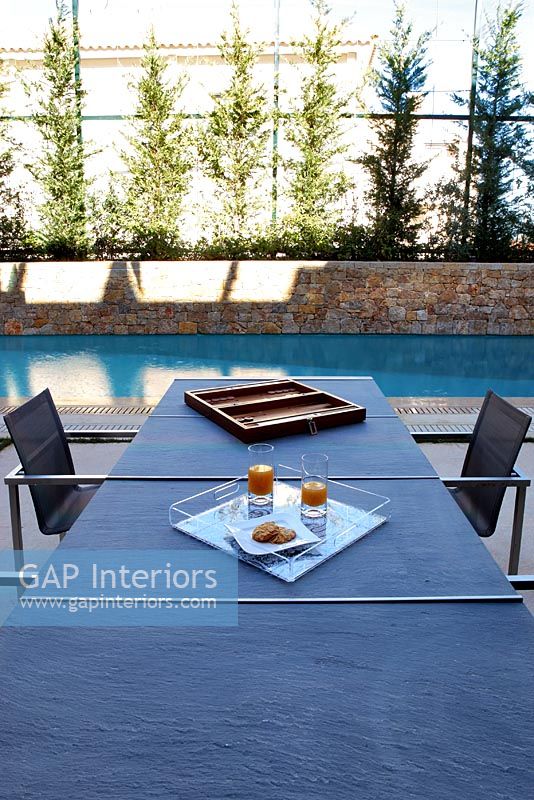 Modern exterior poolside dining table