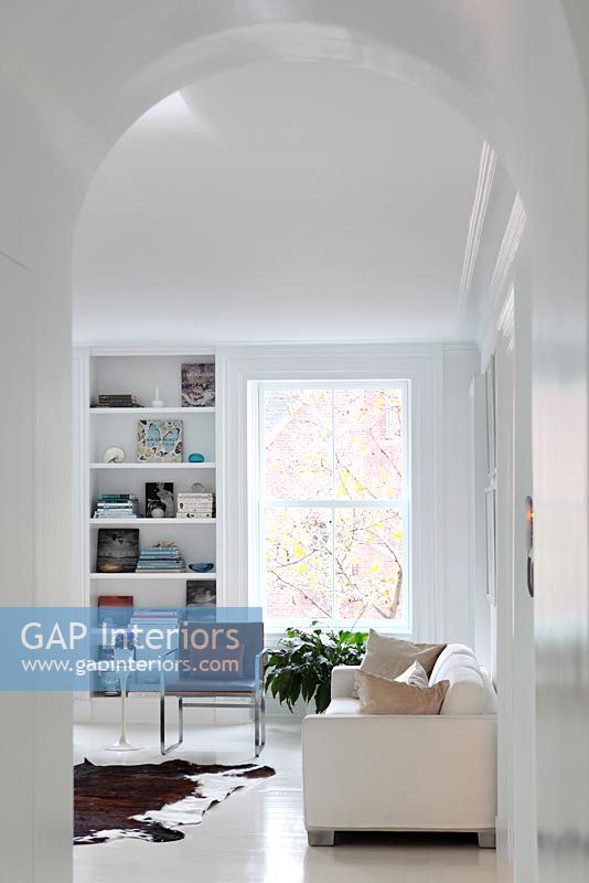 Modern white living room with arched doorway