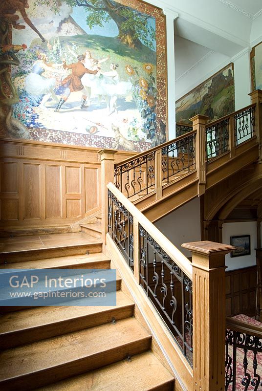 Grand wooden staircase and wall murals