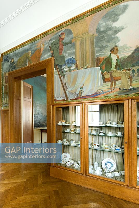 Display cabinets and murals in hallway