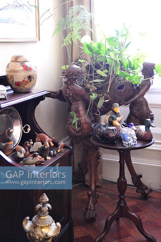 Collectibles on side tables in living room 