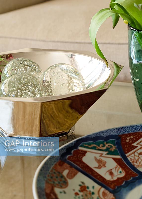 Glass balls displayed in silver bowl, detail