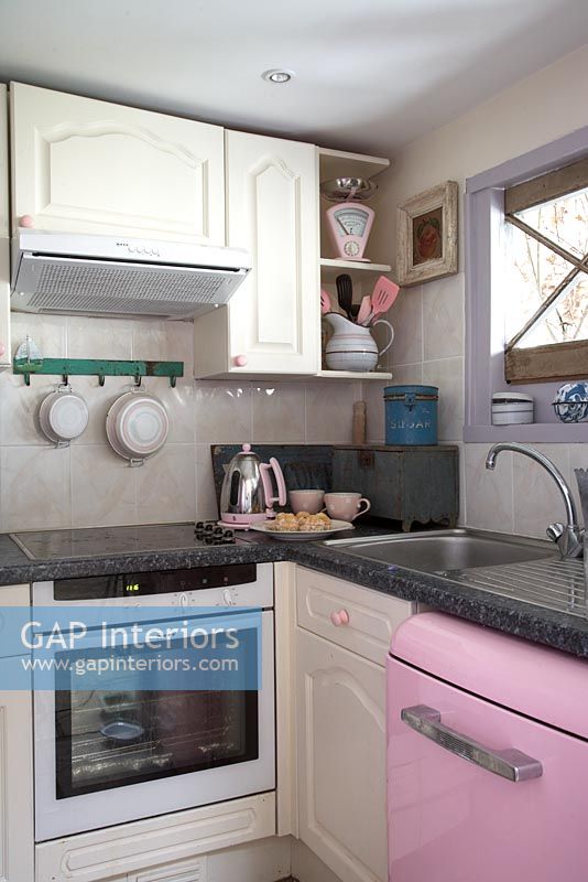 Modern kitchen with pink dishwasher 