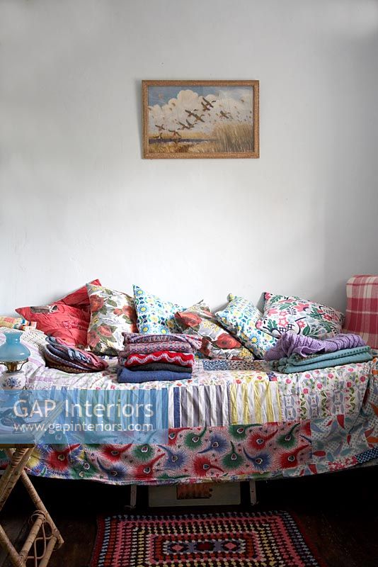 Colourful cushions on daybed