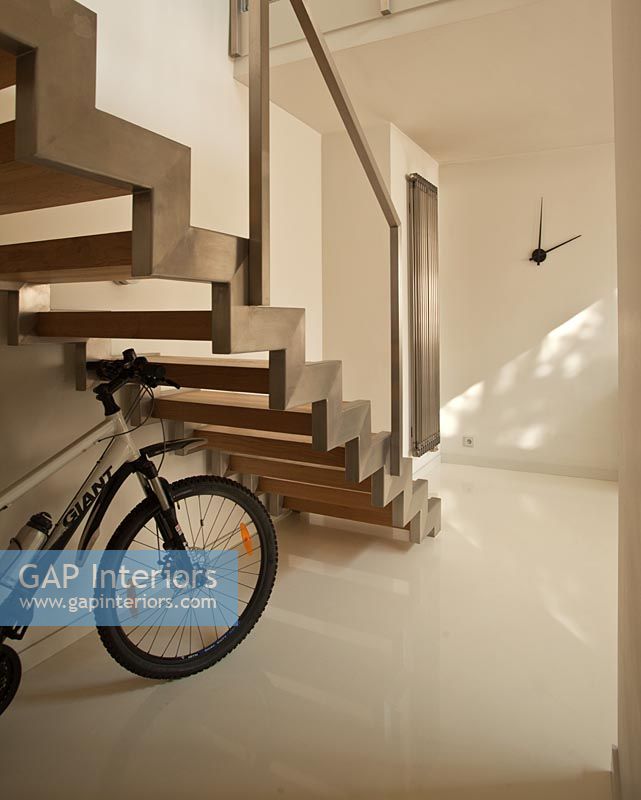 Bicycle under modern staircase 