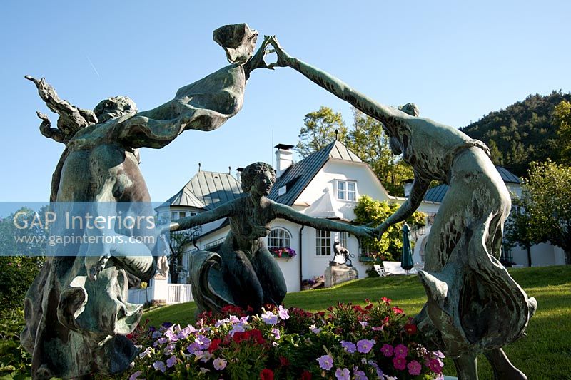 Statues outside large country house 