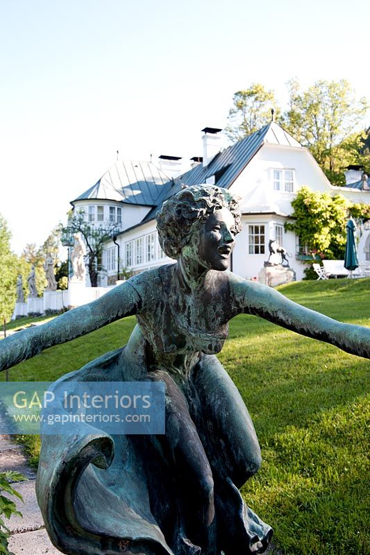 Classic sculpture outside large country house