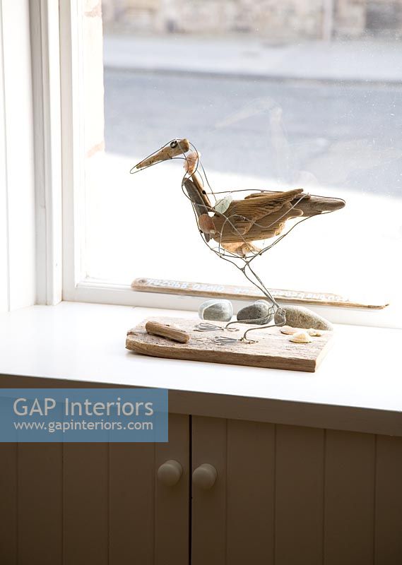 Sea bird sculpture on windowsill 