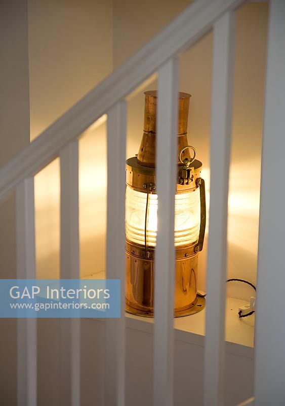 Brass lantern on modern staircase 