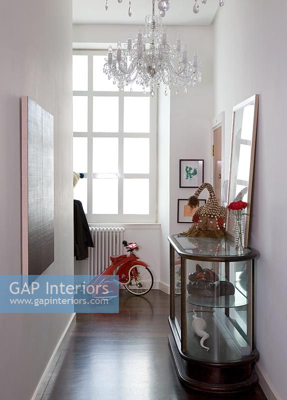 Hallway with display cabinet and childs bike