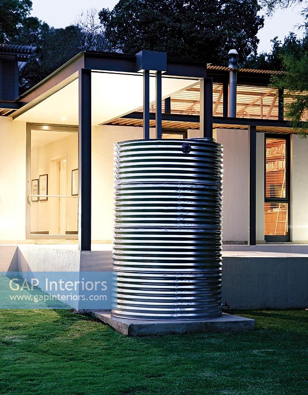 Rainwater drum outside modern house 