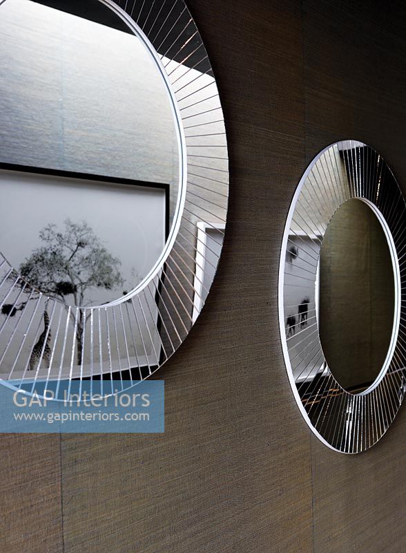 Round mirrors and artwork in modern corridor