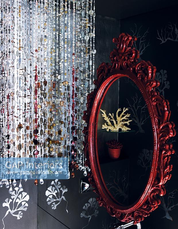 Bead curtain and ornate red mirror, detail