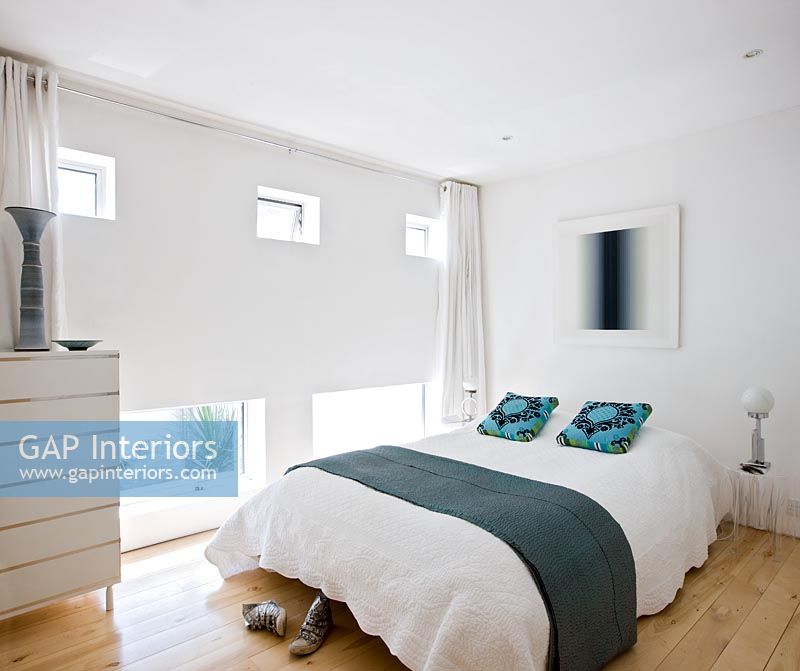White bedroom with turquoise accents
