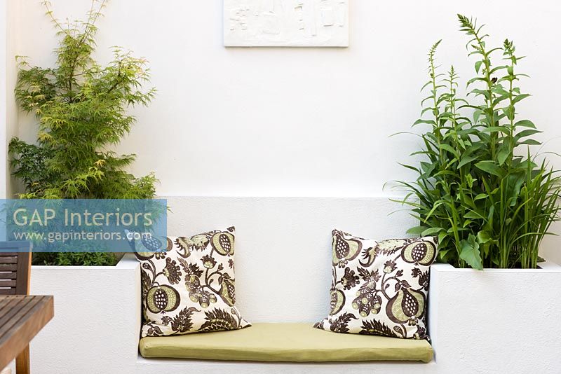Built in garden bench and planters with patterned cushions
