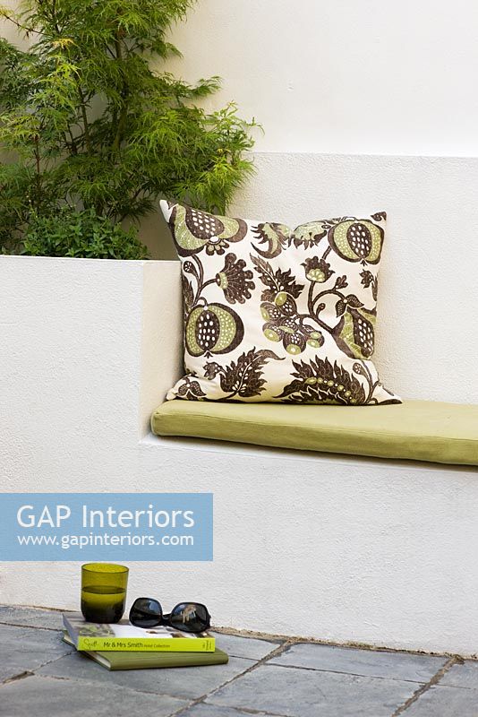 Built in garden bench and planters with patterned cushions