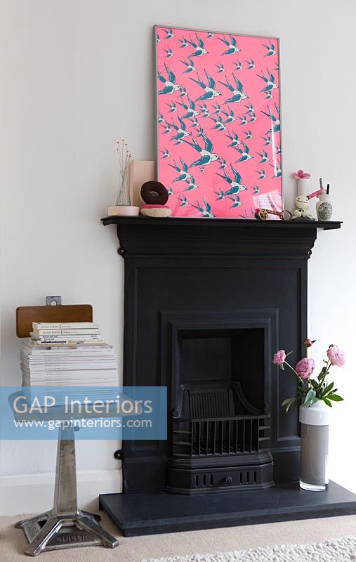 Cast iron fireplace with pink artwork