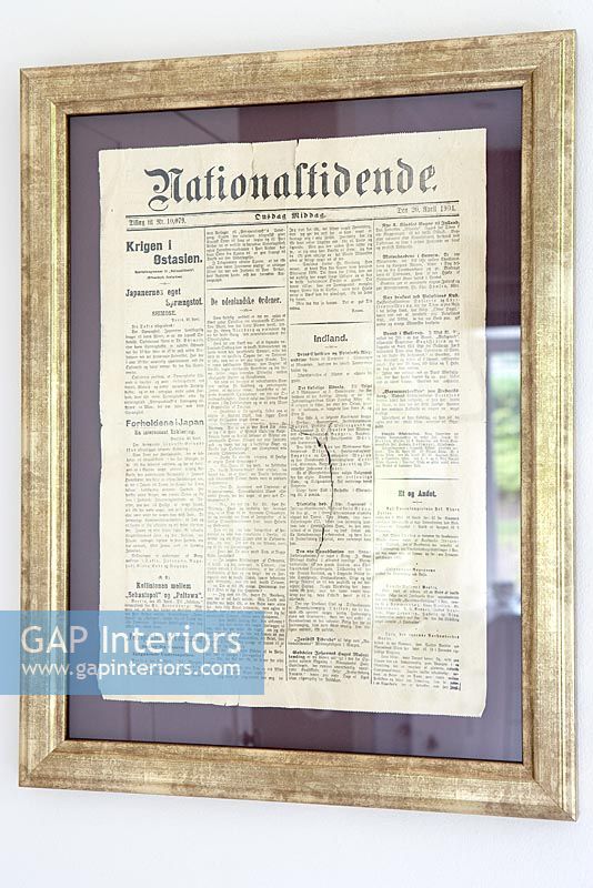 Vintage newspaper clipping in gold frame